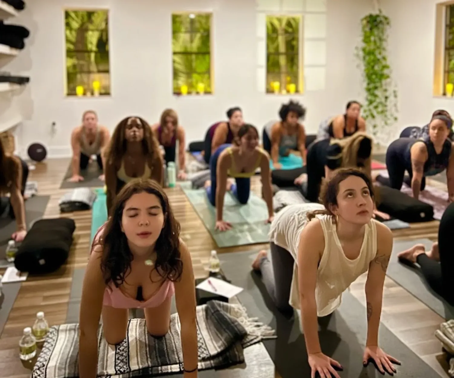 An evening flow class moving together at Kasa Yoga